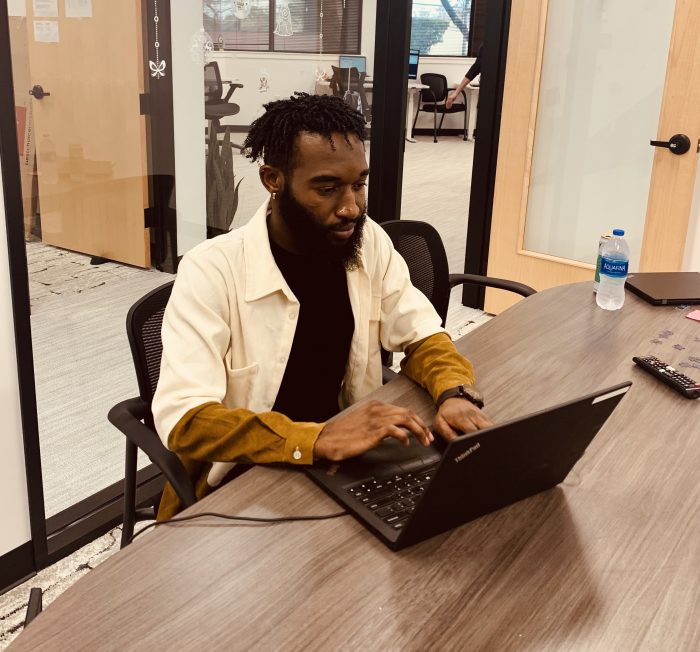 An employee at a laptop at the Austin, TX office of Lone Star Registered Agent