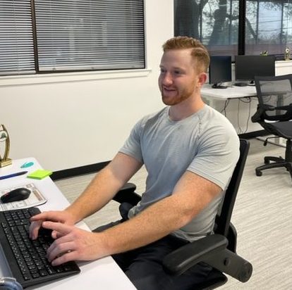 A man works at a computer at the Austin, Texas office of Lone Star Registered Agent.